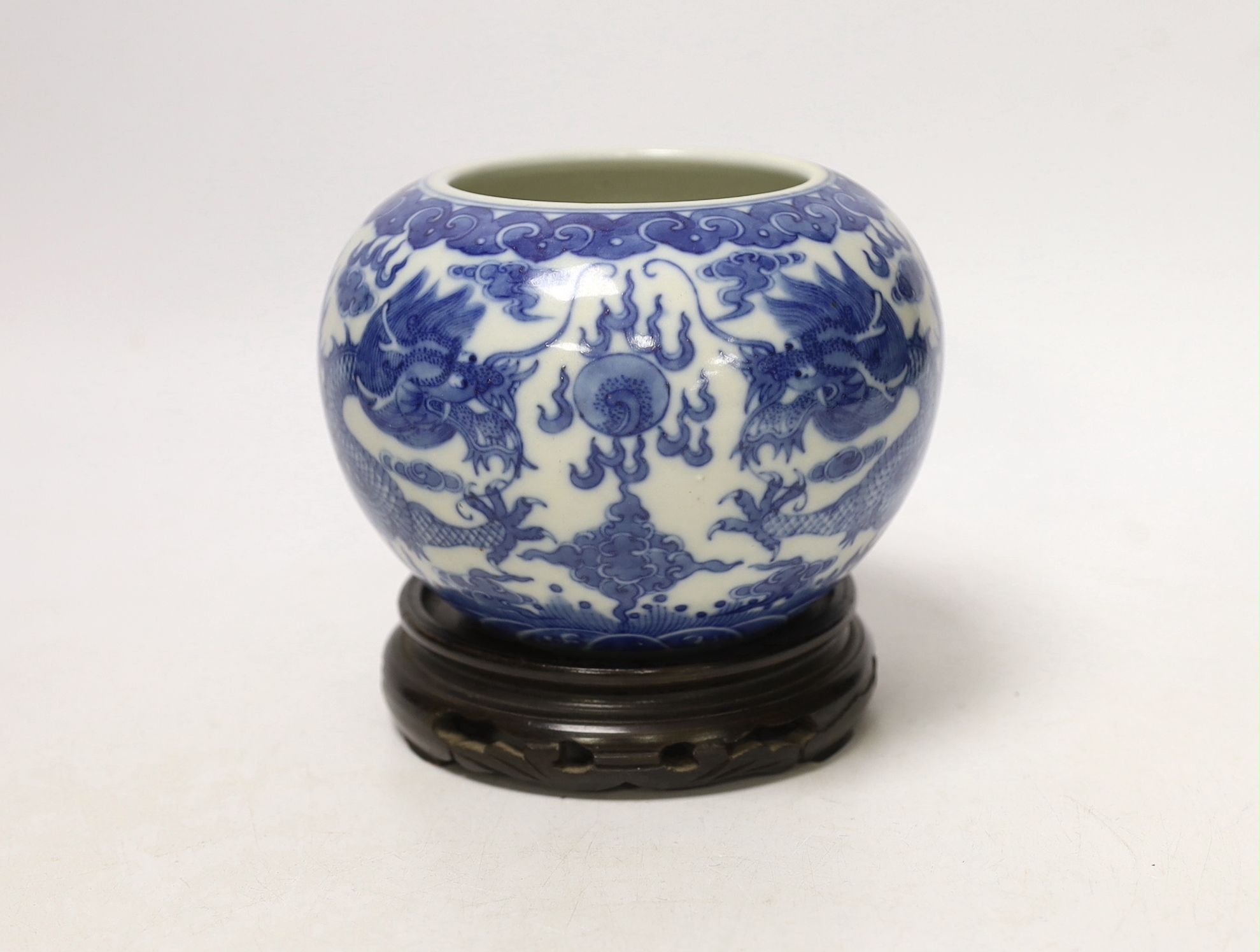 A Chinese blue and white dragon water pot on stand, bowl 12.5cm high including stand